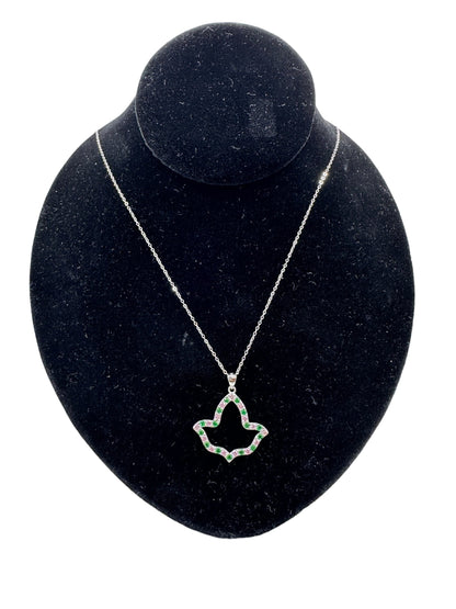 AKA Open Ivy Leaf Necklace made from .925 sterling silver and plated with rhodium, featuring pink and green cubic zirconia diamonds on the edges, displayed on a black velvet stand.