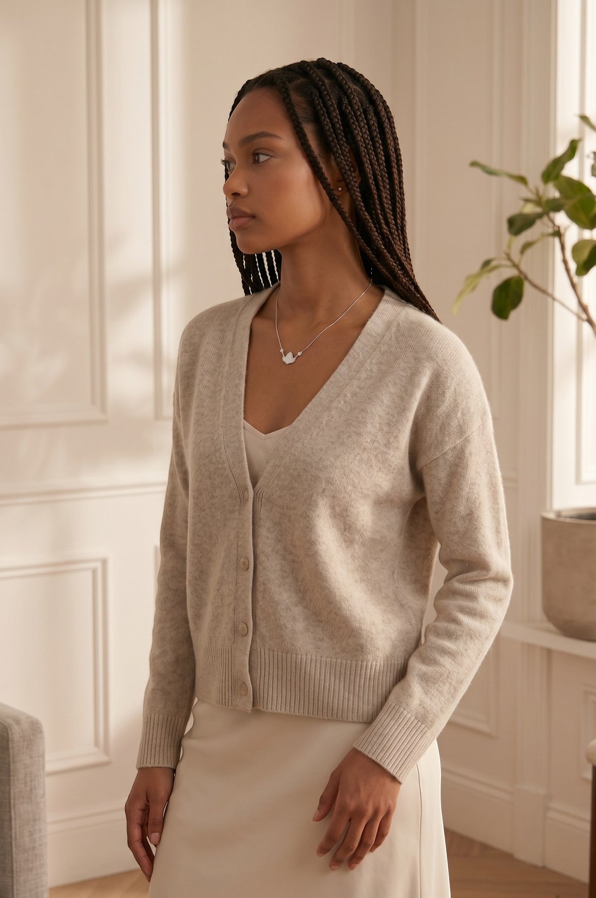 Model wearing a Trendzio Jewelry sterling silver ivy leaf necklace with CZ accents, styled with a beige cardigan.