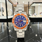 Trendzio Jewelry Blue Amber Mariner automatic watch with orange bezel, blue dial, stainless steel bracelet, and date window.