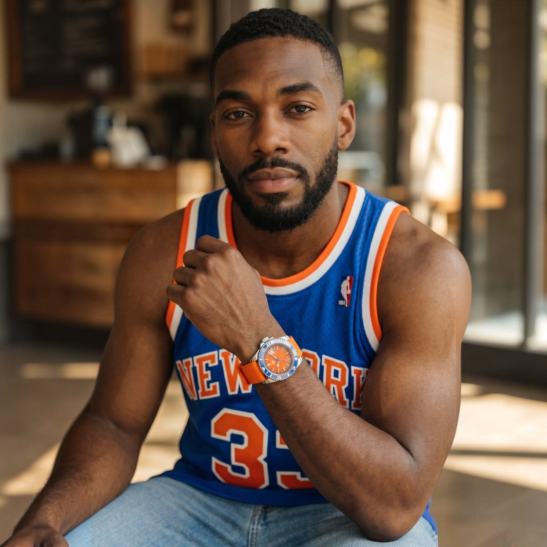 Trendzio Jewelry Blue Amber watch with orange dial, blue bezel, and orange strap on a man wearing a blue basketball jersey.