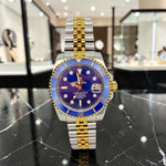Trendzio Jewelry Blue Oro Mariner watch with sunburst blue dial, gold hands, and blue ceramic bezel. Stainless steel bracelet.