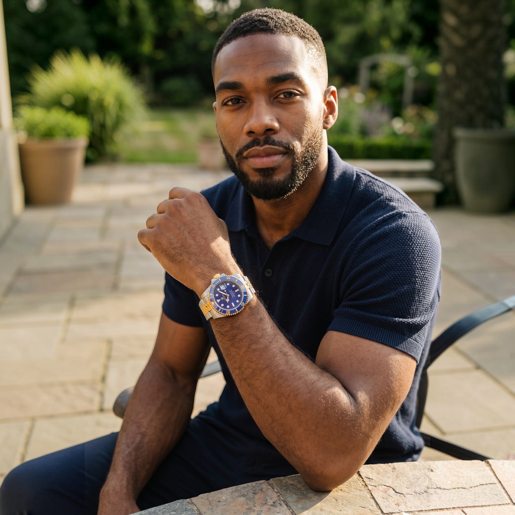 Trendzio Jewelry Blue Oro Mariner watch with gold accents on a man's wrist, featuring a blue sunburst dial and ceramic bezel.