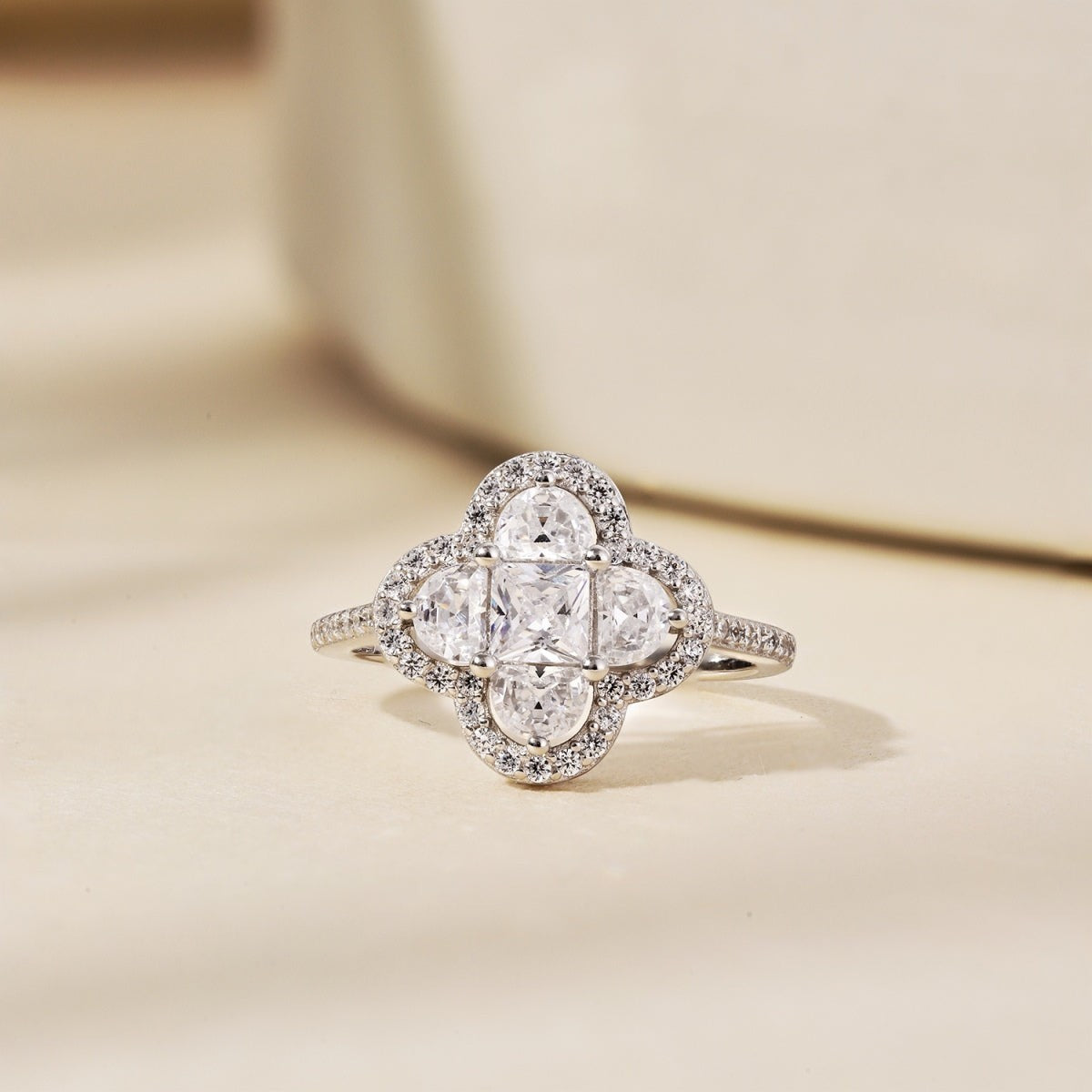 Trendzio Jewelry sterling silver clover ring featuring sparkling CZ diamonds in a halo setting on a neutral background