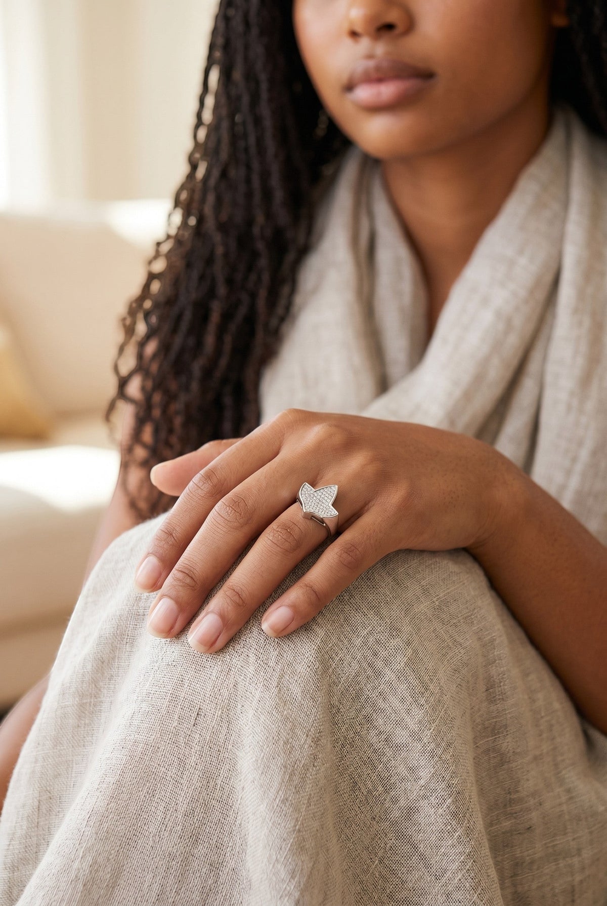 Trendzio Jewelry sterling silver ivy leaf ring with CZ stones worn on a woman's hand, 14k white gold plated finish.