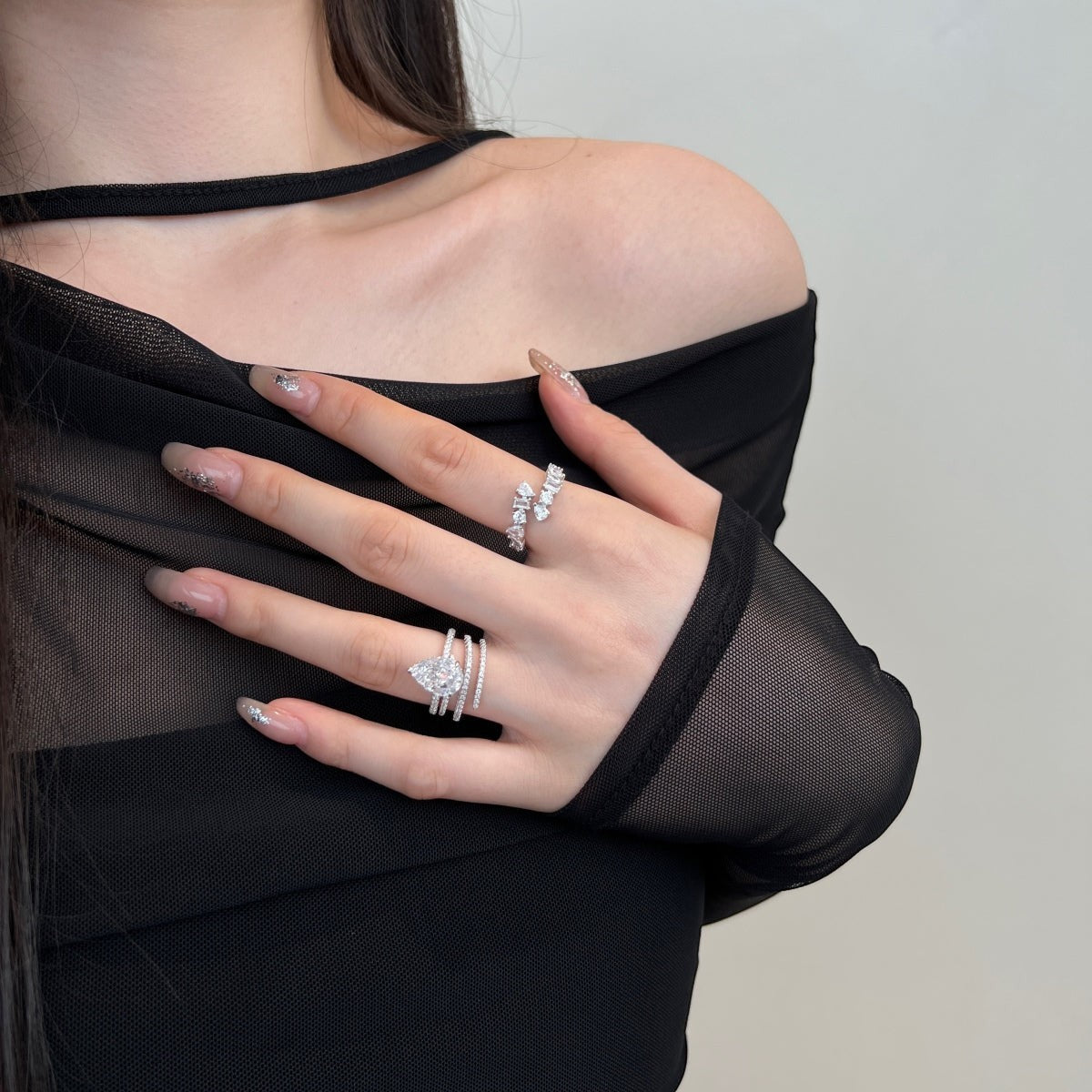 Trendzio Jewelry Lolo sterling silver CZ diamond ring set on a model wearing a black mesh top.