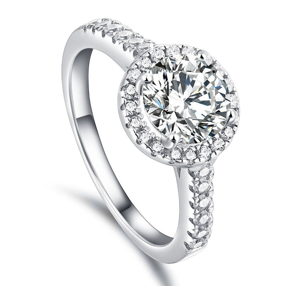 Trendzio Jewelry Lyra sterling silver ring with a round halo CZ diamond and pavé band for a sparkling statement look.