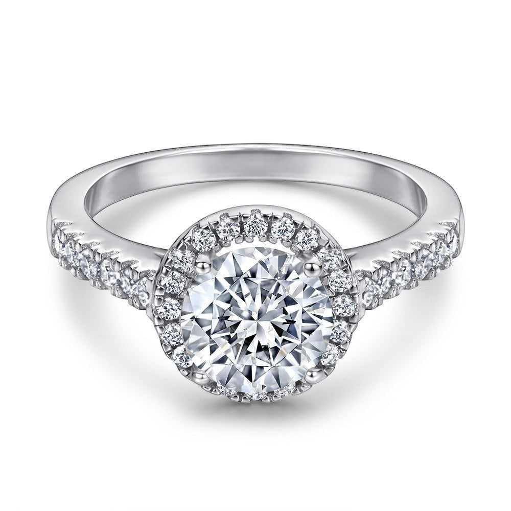 Trendzio Jewelry Lyra sterling silver ring featuring a round halo cubic zirconia stone and pavé band.