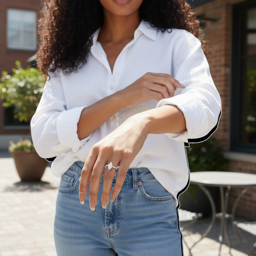 Trendzio Jewelry Uma marquise-cut CZ engagement ring with a silver-tone band on a woman in a white shirt.