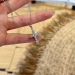 Trendzio Jewelry sterling silver cross necklace featuring sparkling moissanite stones on a delicate chain.