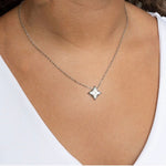 Trendzio Jewelry star pendant necklace with Mother of Pearl inlay on a delicate silver-tone chain worn on a model.