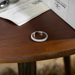 Trendzio Jewelry Nola sterling silver moissanite eternity ring with pavé stones on a wooden table