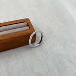 Trendzio Jewelry Nola sterling silver moissanite eternity band ring with sparkling pavé stones in a wooden box.