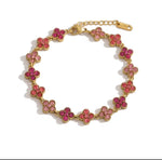 Trendzio Jewelry gold-plated stainless steel clover bracelet featuring pink CZ stones in a waterproof design.