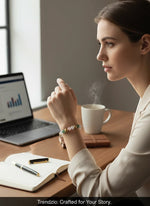 Woman wearing a Trendzio Jewelry pink and green jade stretch bracelet with gold accents while working at a desk.