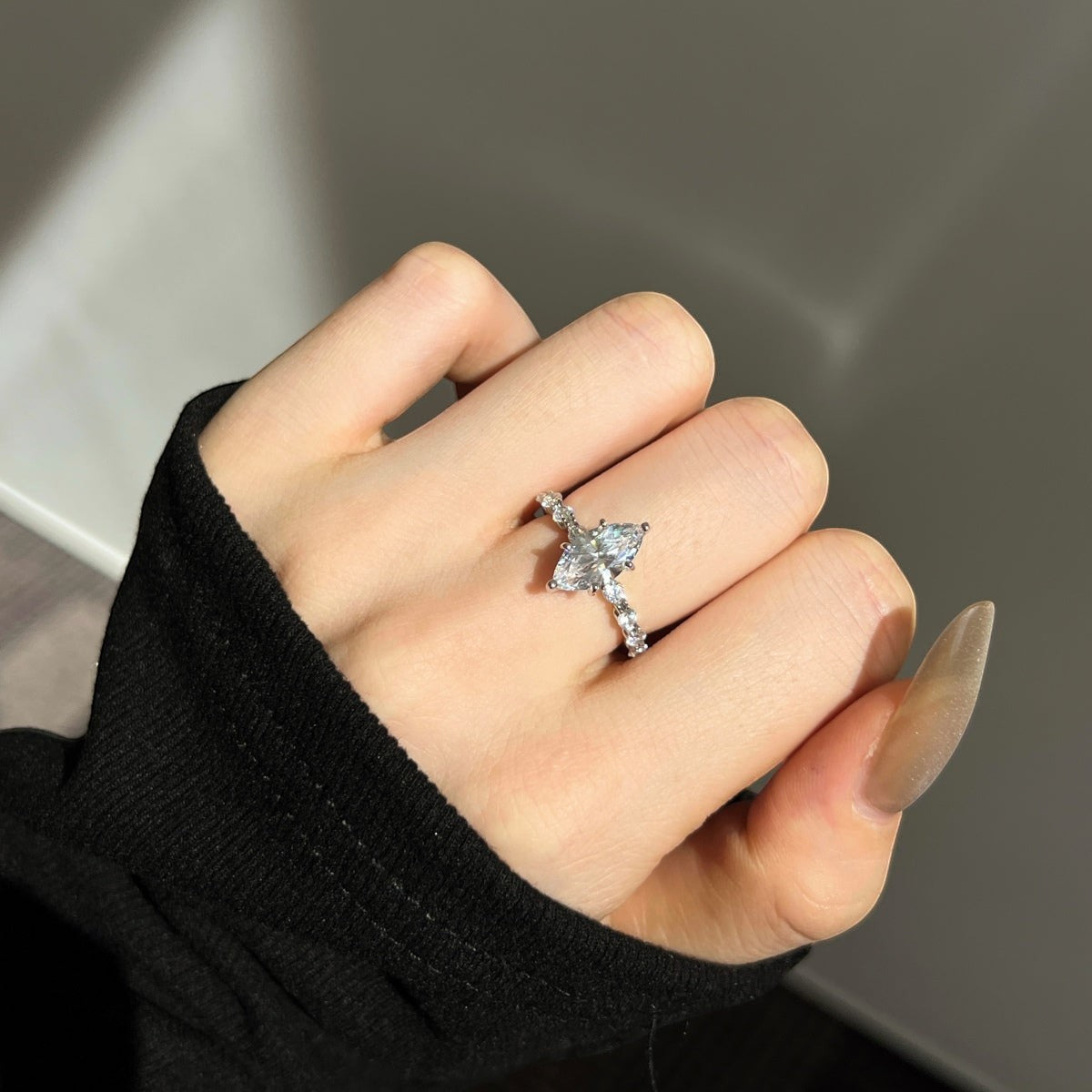 Trendzio Jewelry Uma sterling silver ring with a marquise-cut CZ diamond and pavé band on a hand.