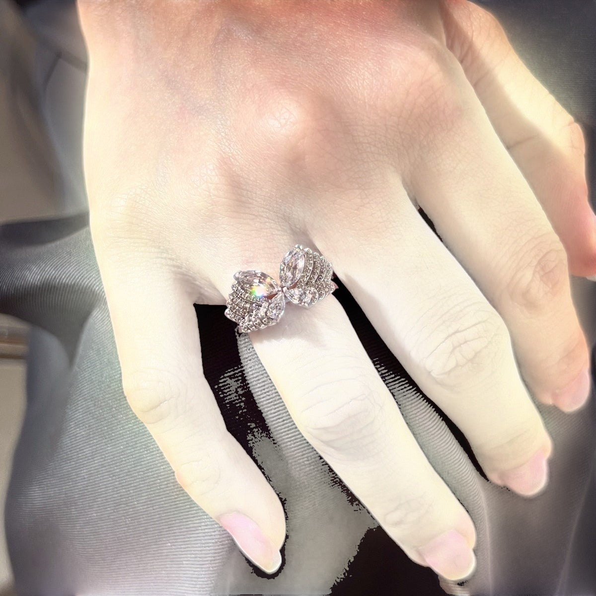 Trendzio Jewelry Veda sterling silver butterfly ring with sparkling cubic zirconia stones worn on a finger.