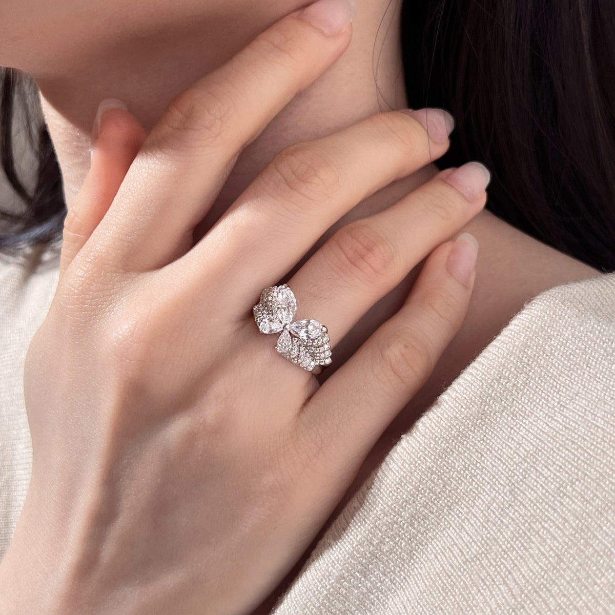 Trendzio Jewelry Veda sterling silver butterfly ring with sparkling cubic zirconia stones worn on a woman's hand.