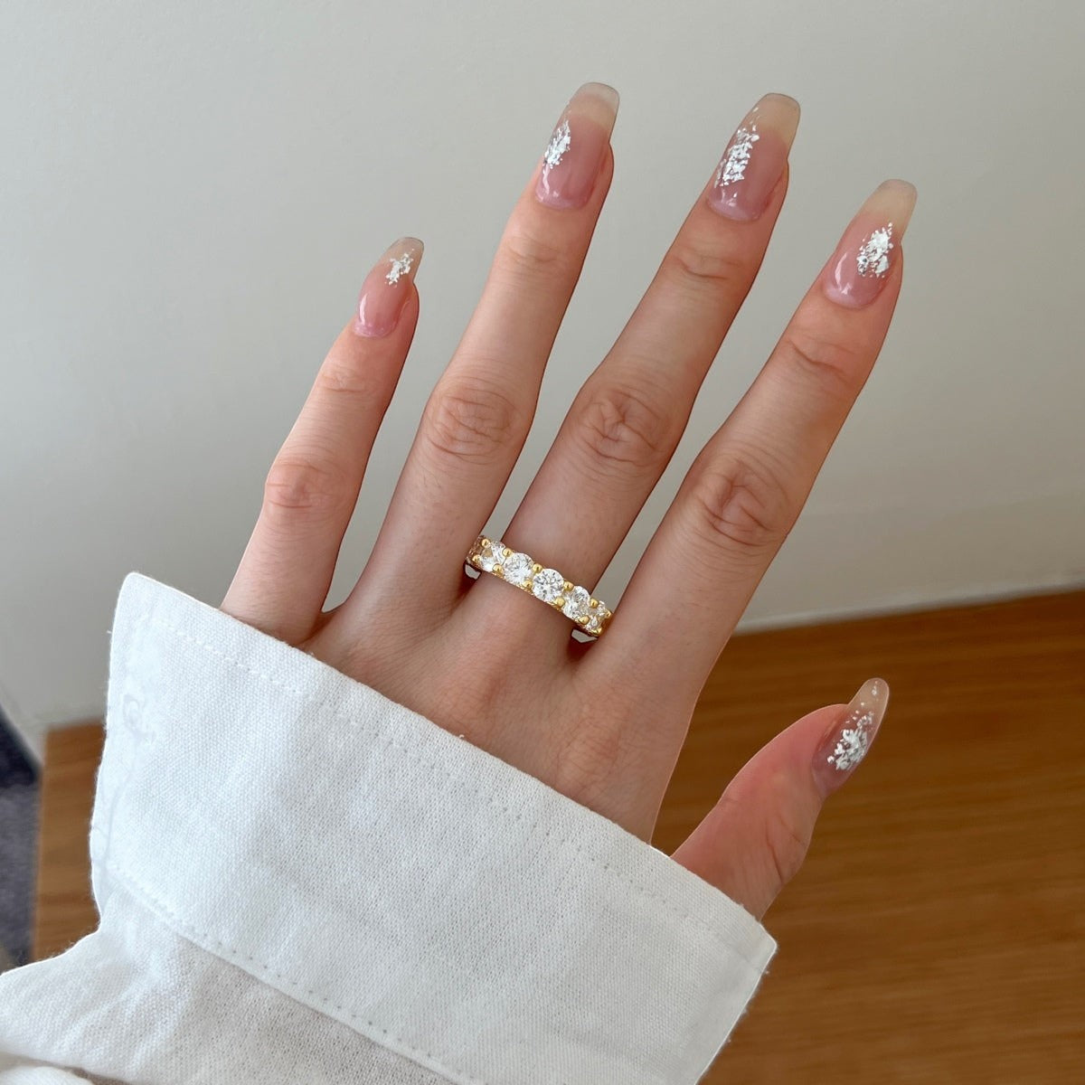 Trendzio Jewelry Zaina CZ diamond ring in 14k gold-plated sterling silver worn on a hand with elegant nail art.