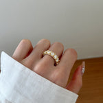 Trendzio Jewelry Zaina CZ diamond ring in 14k gold plated sterling silver on a finger with a white sleeve
