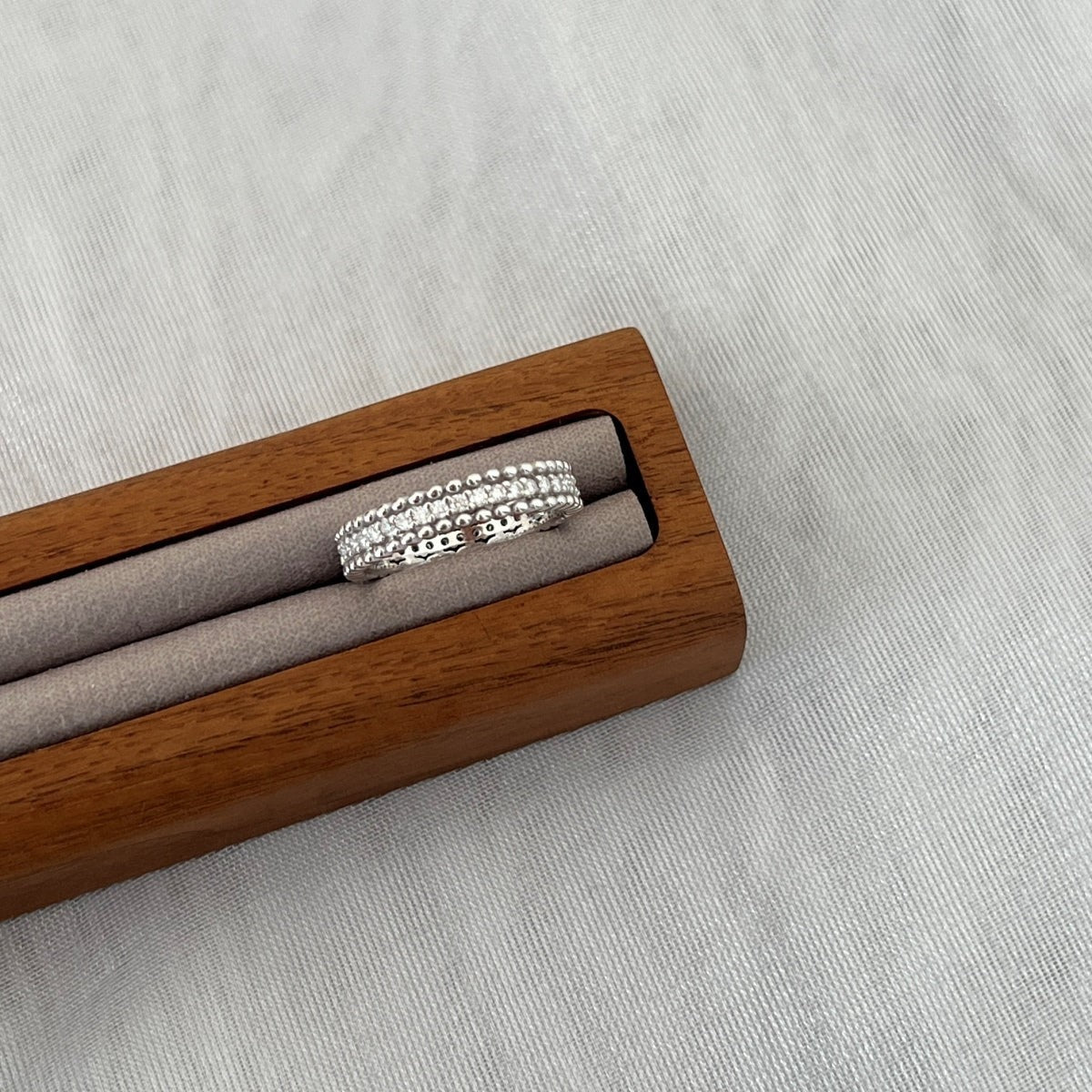 Trendzio Jewelry Zora sterling silver moissanite ring with beaded edges in a wooden display box