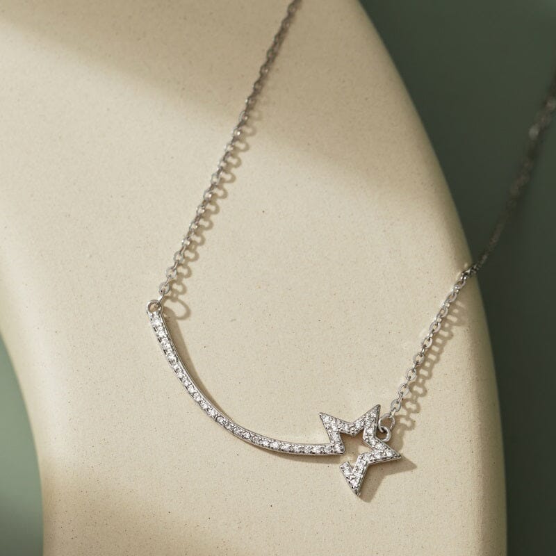 Silver Star Necklace with sparkling star-shaped pendant on a delicate silver chain, showcased on a light beige background.